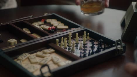 Two-Men-Playing-Mini-Chess-in-Warm-Cabin-During-the-Winter