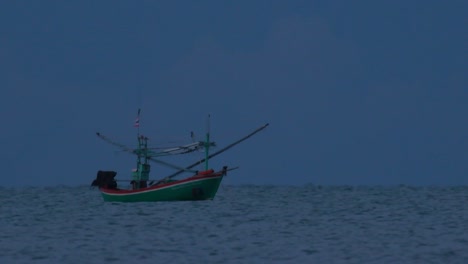 los barcos de pesca en tailandia esperan en medio del océano a que oscurezca para poder encender sus luces verdes y comenzar a pescar y pescar camarones
