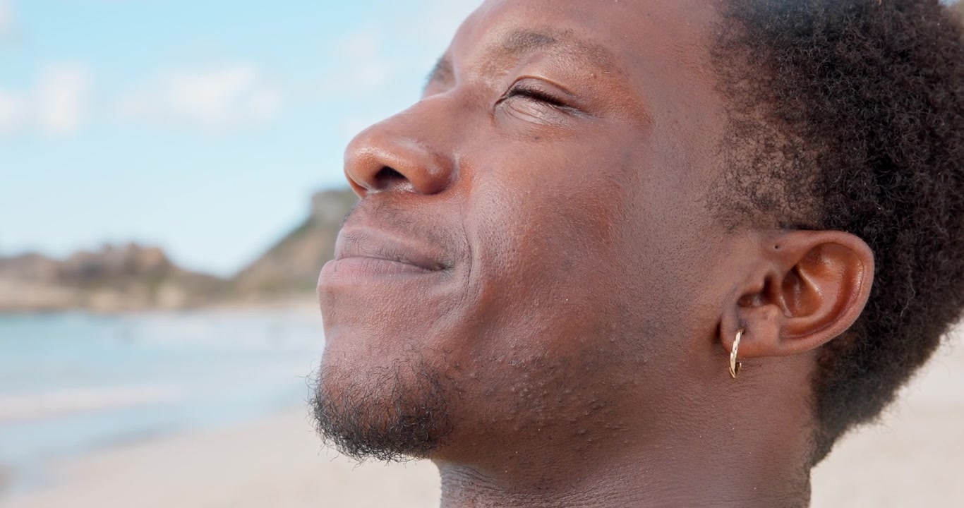 Young Man Relaxing and Breathing Deeply on the Beach