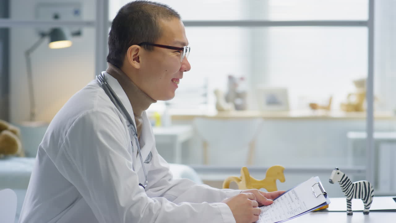 Pediatrician Speaking with Asian Mother of Little Girl