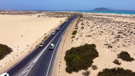 A-jeep-with-surf-boards-is-driving-away-from-the-beach