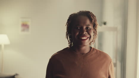 friendly african american woman looks in camera smiling