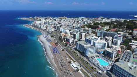 aerial view following the coastline of the rhodes city, sunny day in greece