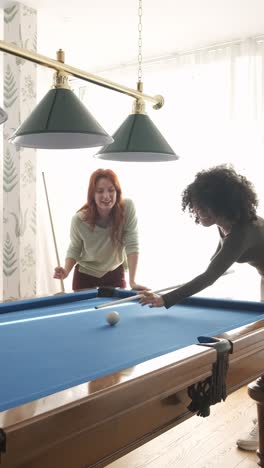 group of diverse friends playing pool game