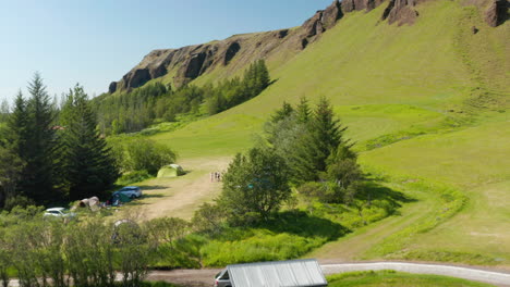 Luftaufnahme-Der-Grünen-Isländischen-Landschaft-Mit-Menschen,-Die-Campen.-Drohnenansicht-Der-Grünen-Wiese-Des-Isländischen-Hochlandes.-Schöne-Aussicht-Auf-Die-Isländische-Landschaft,-Die-Mit-Saftig-Grünem-Gras-Bedeckt-Ist