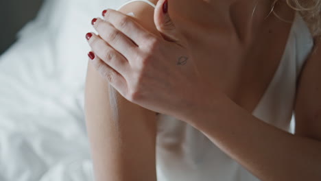 closeup woman applying lotion on body. girl enjoying nourishing beauty procedure