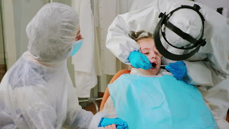 Close-up-of-girl-patient-in-coverall-lying-on-stomatological-chair-with-open-mouth