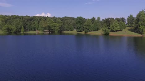 drone flies over woman as she paddles kayak on a beautiful day