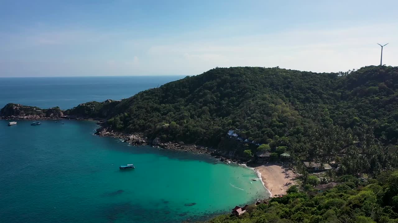 Drone aerial shot of beach bay and island with turquoise water in Koh Tao, Thailand