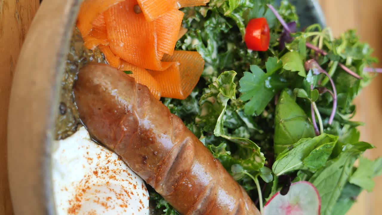 Breakfast plate with sausage, egg, and salad