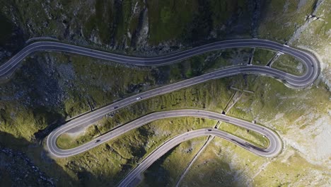 Static-aerial-shot-over-section-of-winding-mountain-road-with-cars