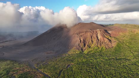 smoke from active volcano in tanna island, vanuatu. drone pull back, sunset, golden hour landscape.