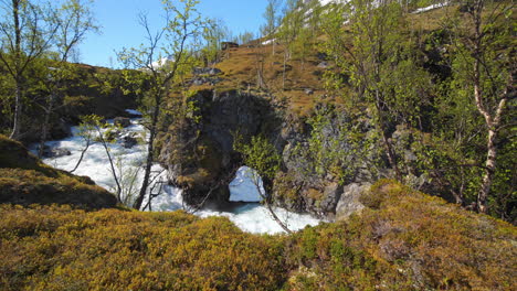 pan view of rapids in the highlands of the lyngen alps, on a sunny, summer day, in north norway