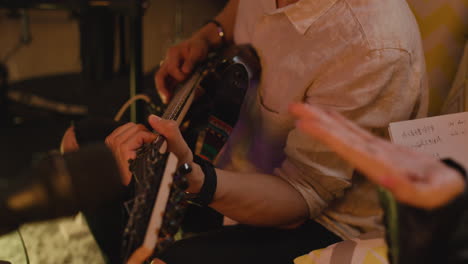 people writing music and playing guitar