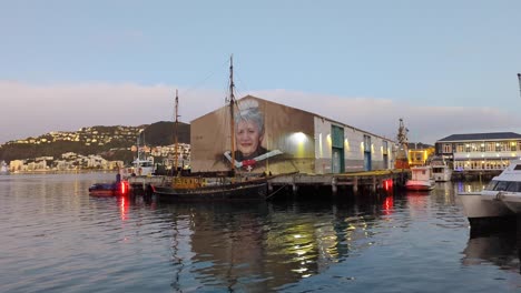 mural of a woman in wellington harbor at dusk