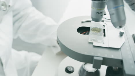 scientist using microscope in laboratory