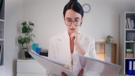 una mujer de negocios analiza un informe financiero en una carpeta.