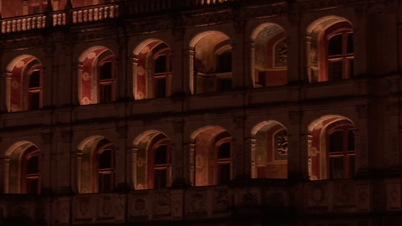 Footage capturing windows of Royal Castle of Blois, France during nighttime. Vacant corridors.