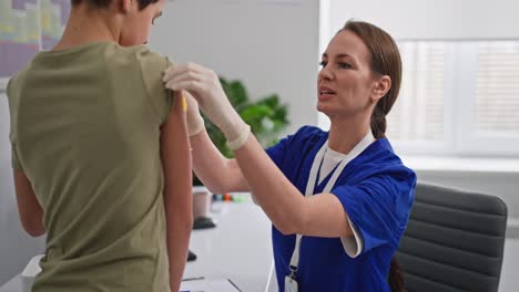doctor administering vaccination to a child