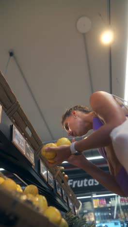 woman selecting fresh fruits in a supermarket