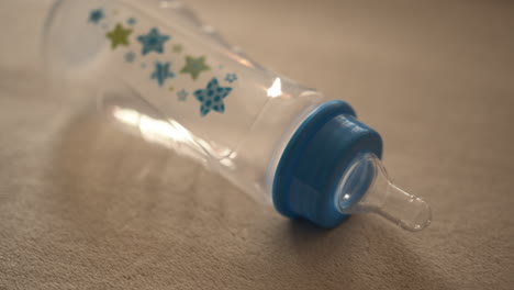 Close-Up-Pan-of-Empty-Baby-Bottle