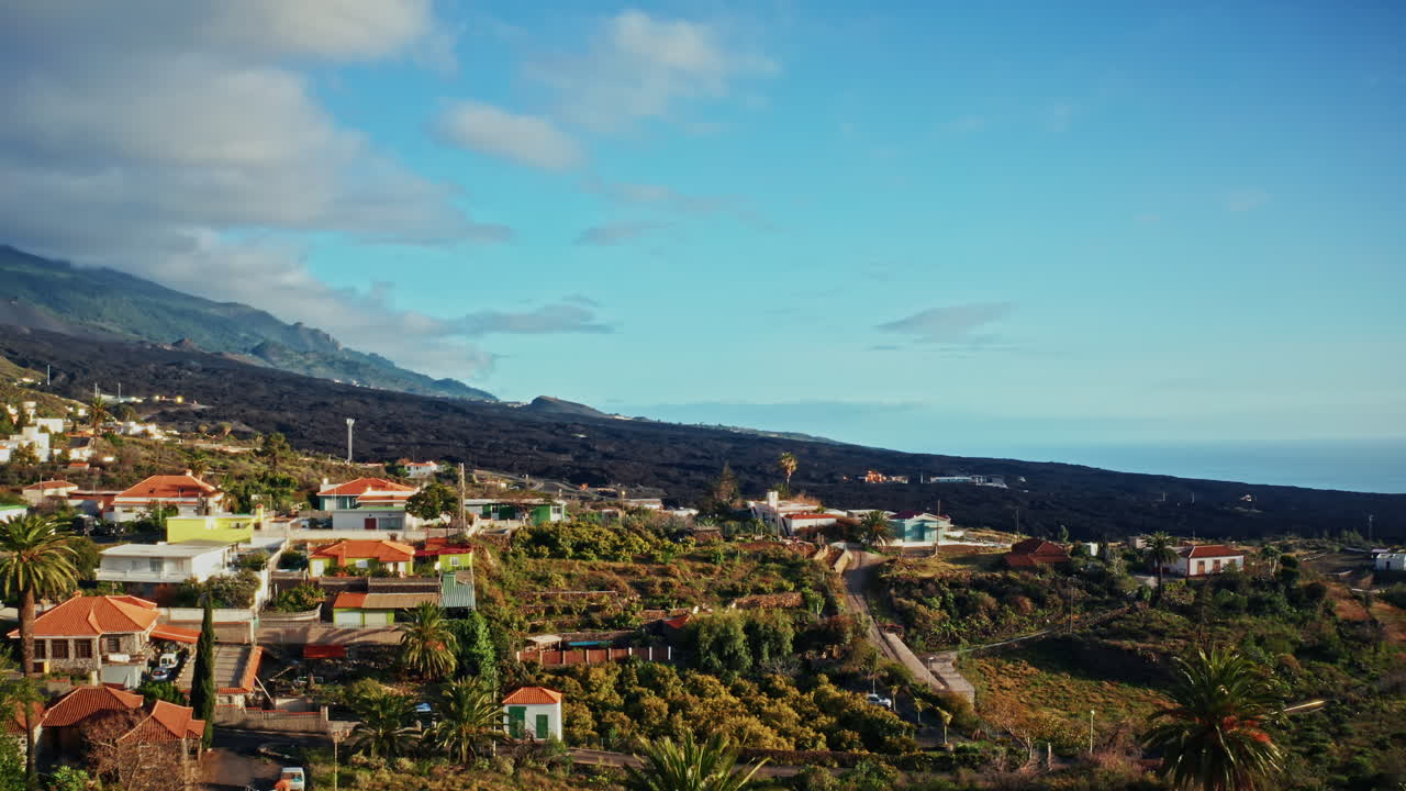 Aerial drone shot over the erupted volcano of Tajogaite in La Palma Island, Canary Islands, Spain. High view of the crater and the back volcanic landscape. Devastated terrain from the lava.