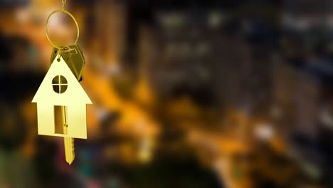 Animation-of-gold-house-key-and-fob-over-out-of-focus-cityscape