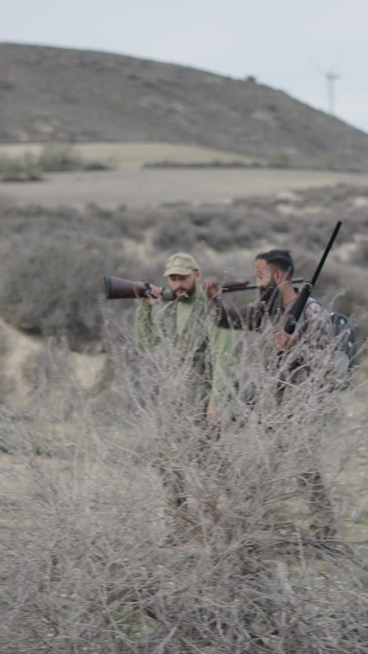 Hunters in a field with rifles