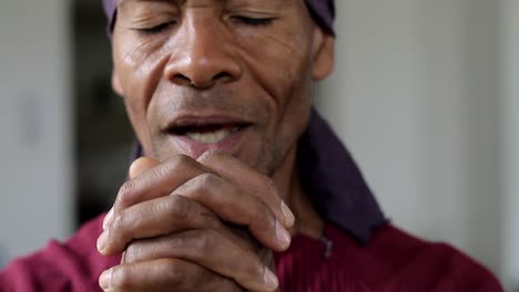 man-praying-to-god-with-hands-together-Caribbean-man-praying-with-background-with-people-stock-footage