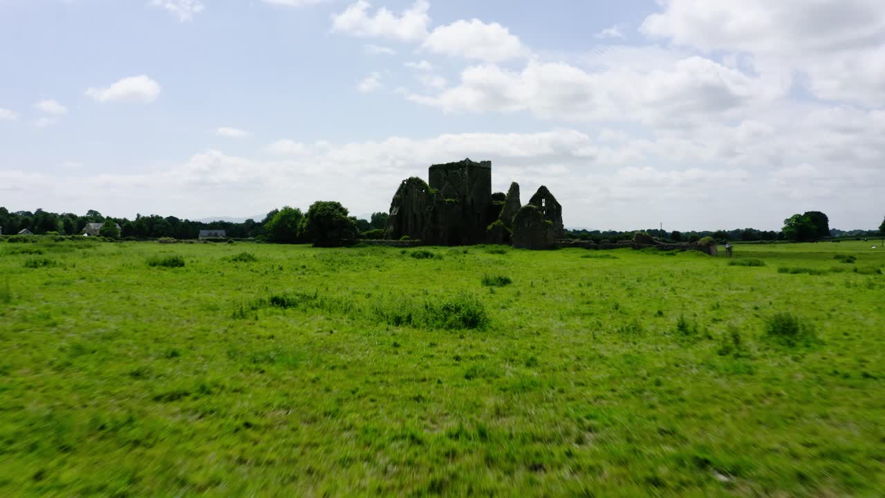 Shot racing over vegetation towards an abandoned castle.