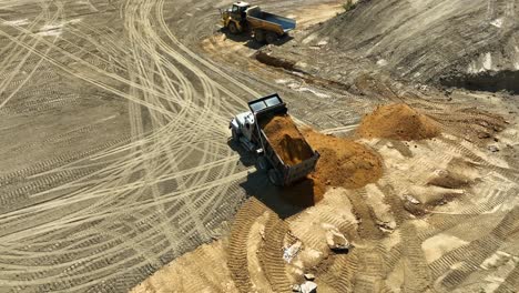 dump truck on worksite dumping dirt