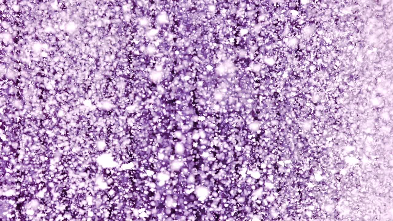 Slow motion snowfall with thick, clustered snowflakes near violet textured wall