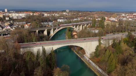 bridges over river aare with car and train traffic in bern city