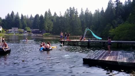 people enjoying the summertime while having fun with the cool waters of the mountain lake in washington, usa - medium shot