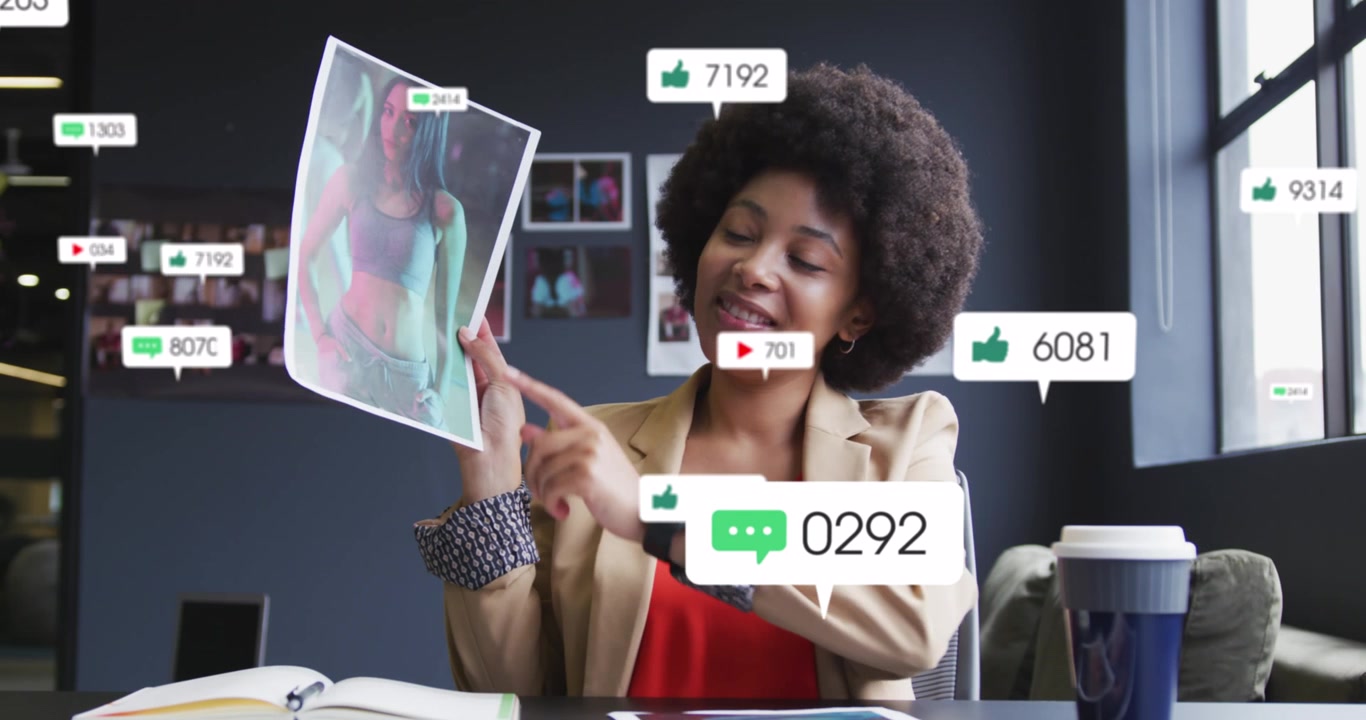 Animation of social media icons and numbers over african american businesswoman