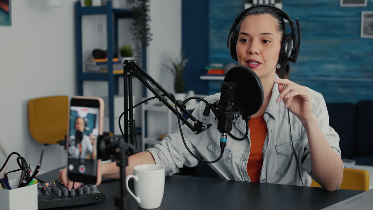 Famous influencer streaming remote podcast using smartphone while talking to audience