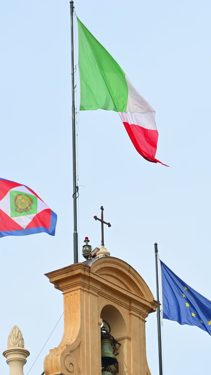 The flags of Italy and European Union and Italian Presidential pennant waving outside the Quirinale Palace in Rome, Italy. Vertical
