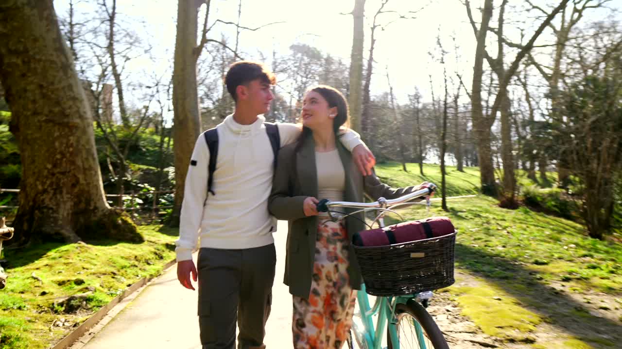 Couple Walking in the Park with Bicycle