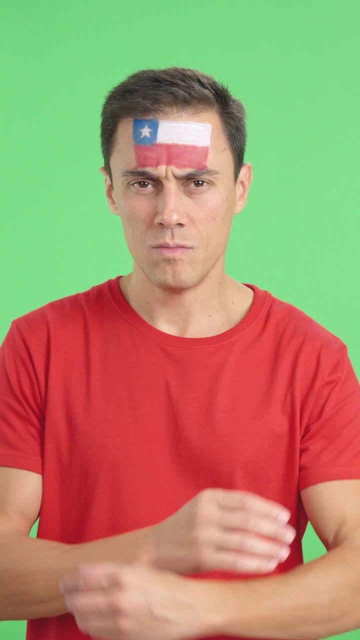 Dignified and serious man with chilean flag painted on face