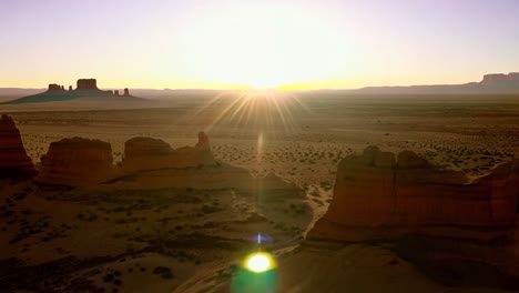 sunset over a desert landscape with rock formations