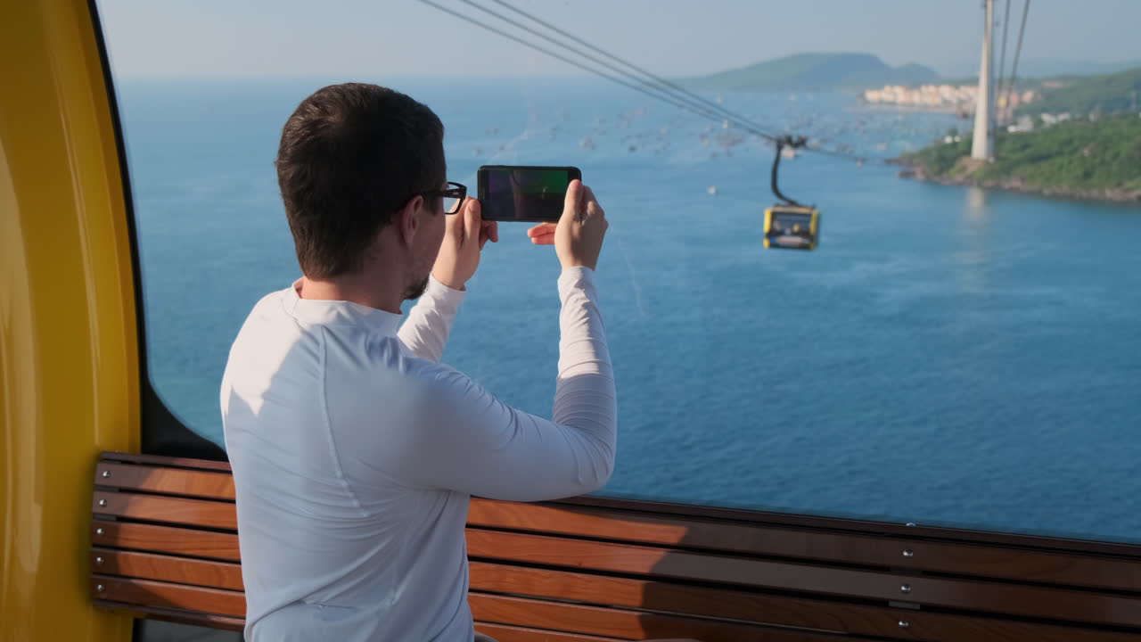 hombre tomando una foto de la vista del teleférico