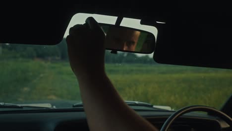 adjusting a car mirror