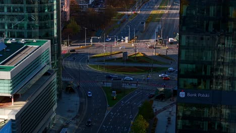 warsaw, poland, drone shot, traffic on onz circle and modern city center buildings on sunny autumn day