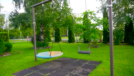 Beautifully-lit-footage-of-a-swing-rocking-back-and-forth-in-a-garden-during-the-summer-time-and-daylight-shot-in-4K-in-Tallinn-Estonia-Europe