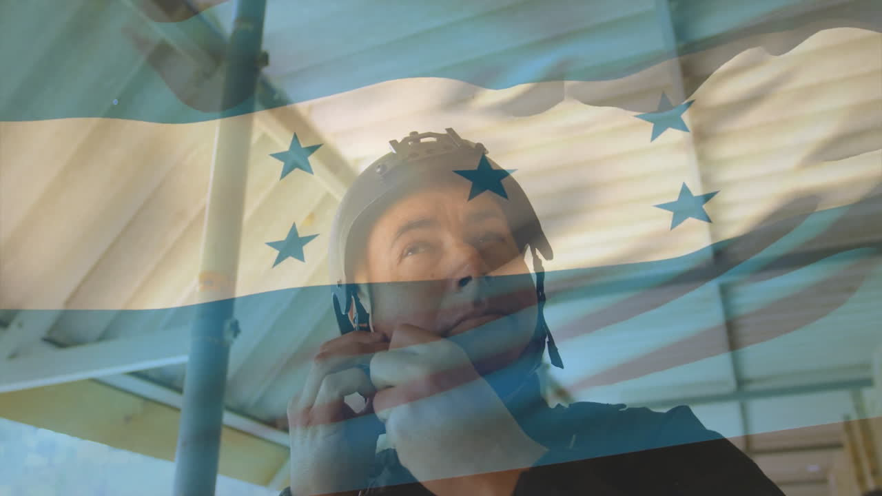 Wearing helmet, man with Honduras flag animation gestures in school environment