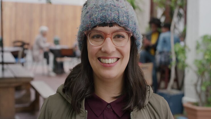 ritratto di una donna hipster felice che indossa occhiali funky sorridendo allegra guardando la telecamera
