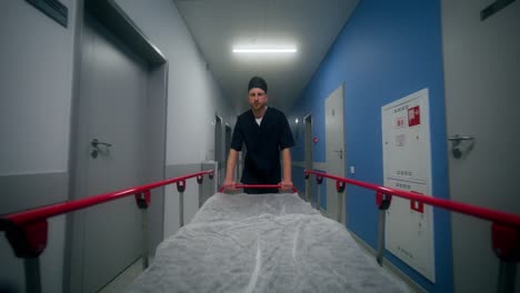 doctor pushing a stretcher in a hospital hallway