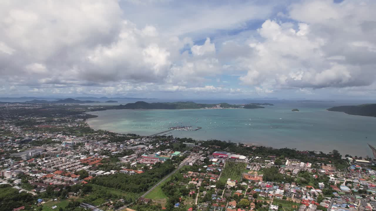 Phuket, aerial drone shot over a Rawai Mueang district on a beautiful sunny day, a turquoise lagoon facing Phi Phi island in a famous Thailand tourist location