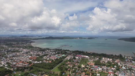 phuket, aerial drone shot over a rawai mueang district on a beautiful sunny day, a turquoise lagoon facing phi phi island in a famous thailand tourist location