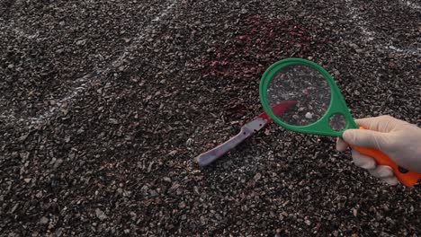 Investigator verifying or examining the murdered blood knife near chalk outlined dead body with Magnifying Glass